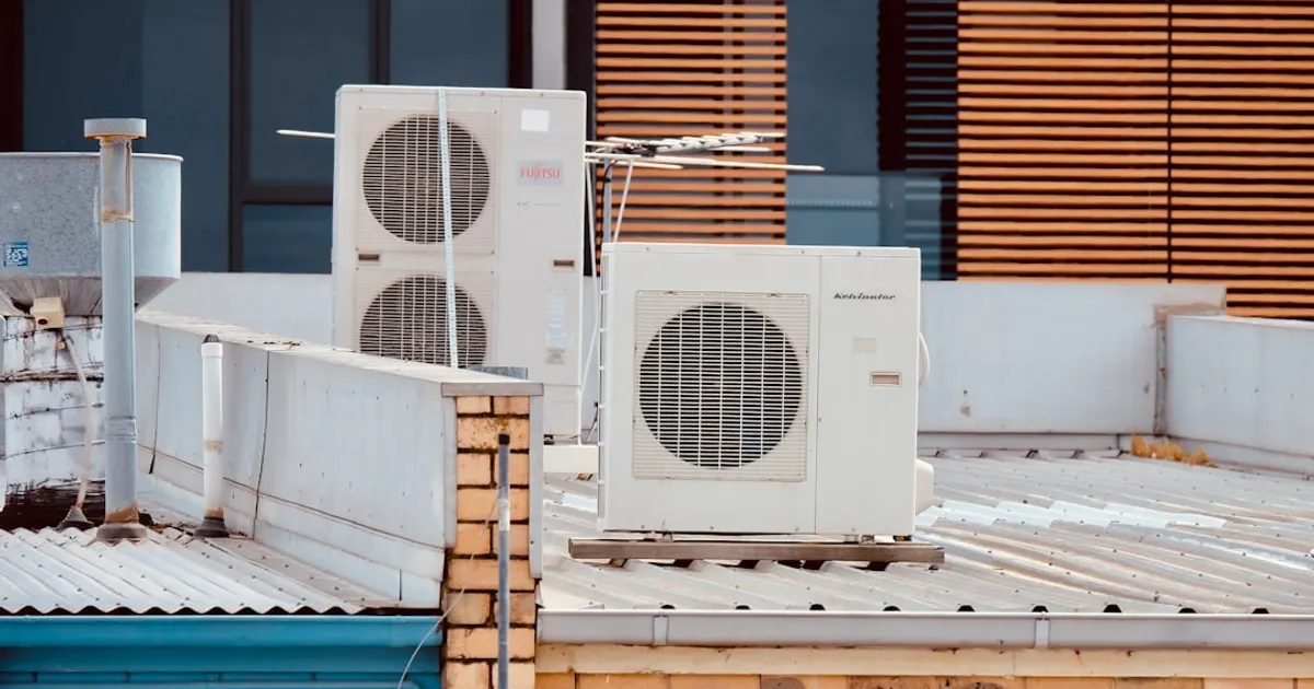 White and gray box fan on brown wooden table