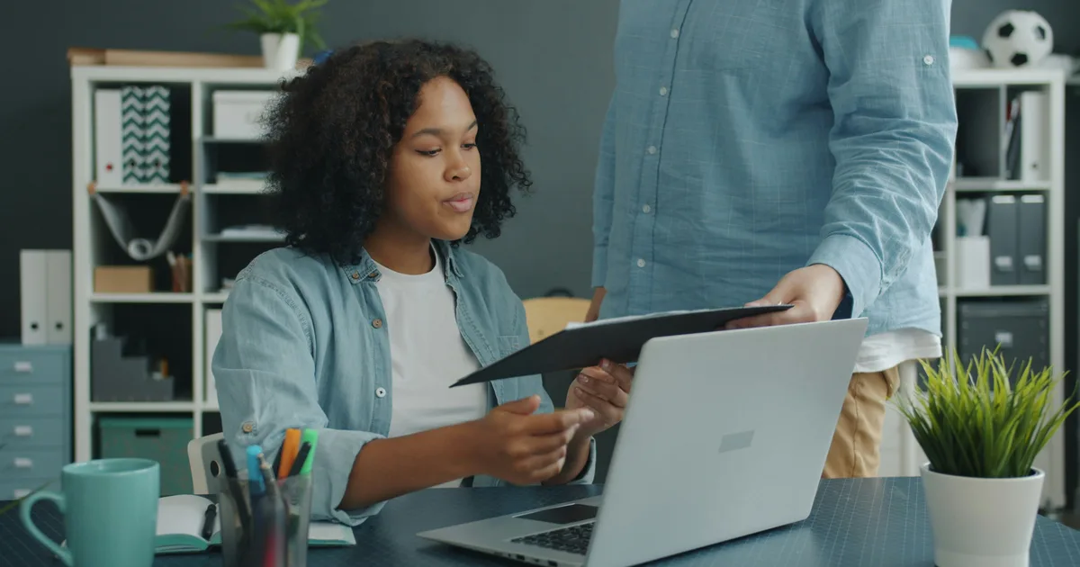 Plumbing company owner reviewing marketing reports on a laptop